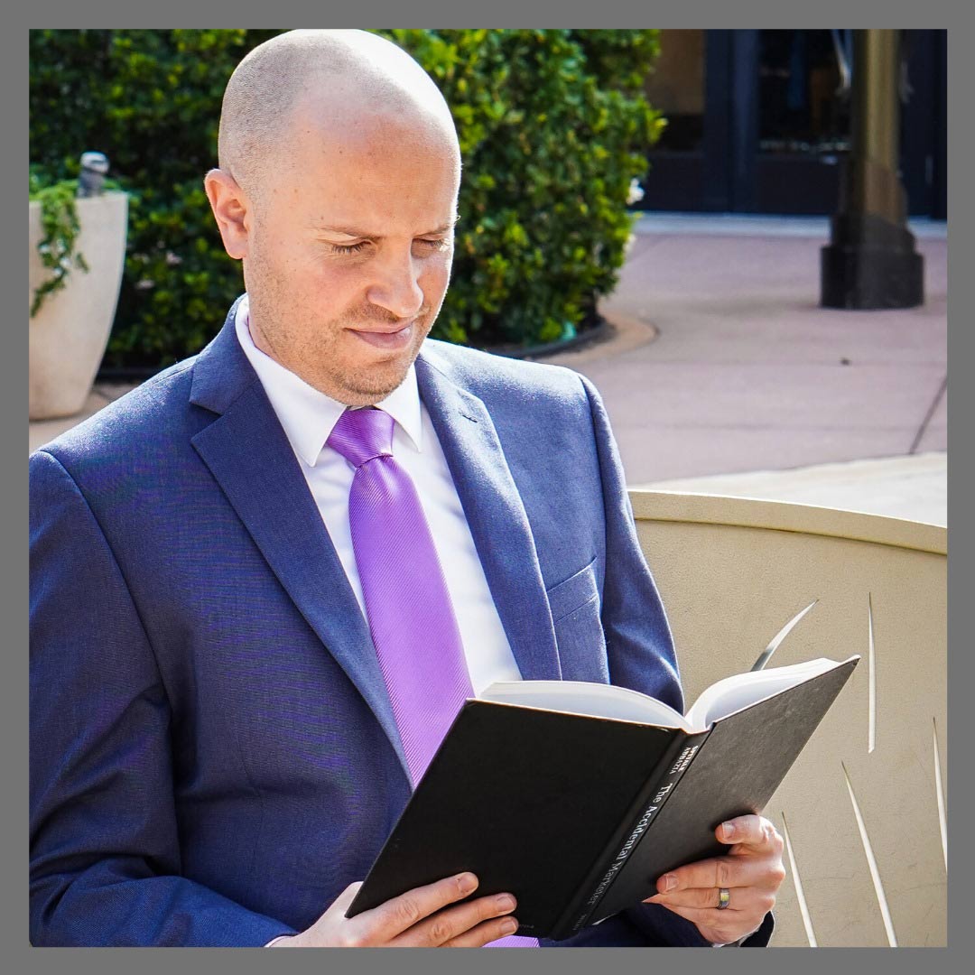 Attorney Adam H. Itzkowitz reading a book outside